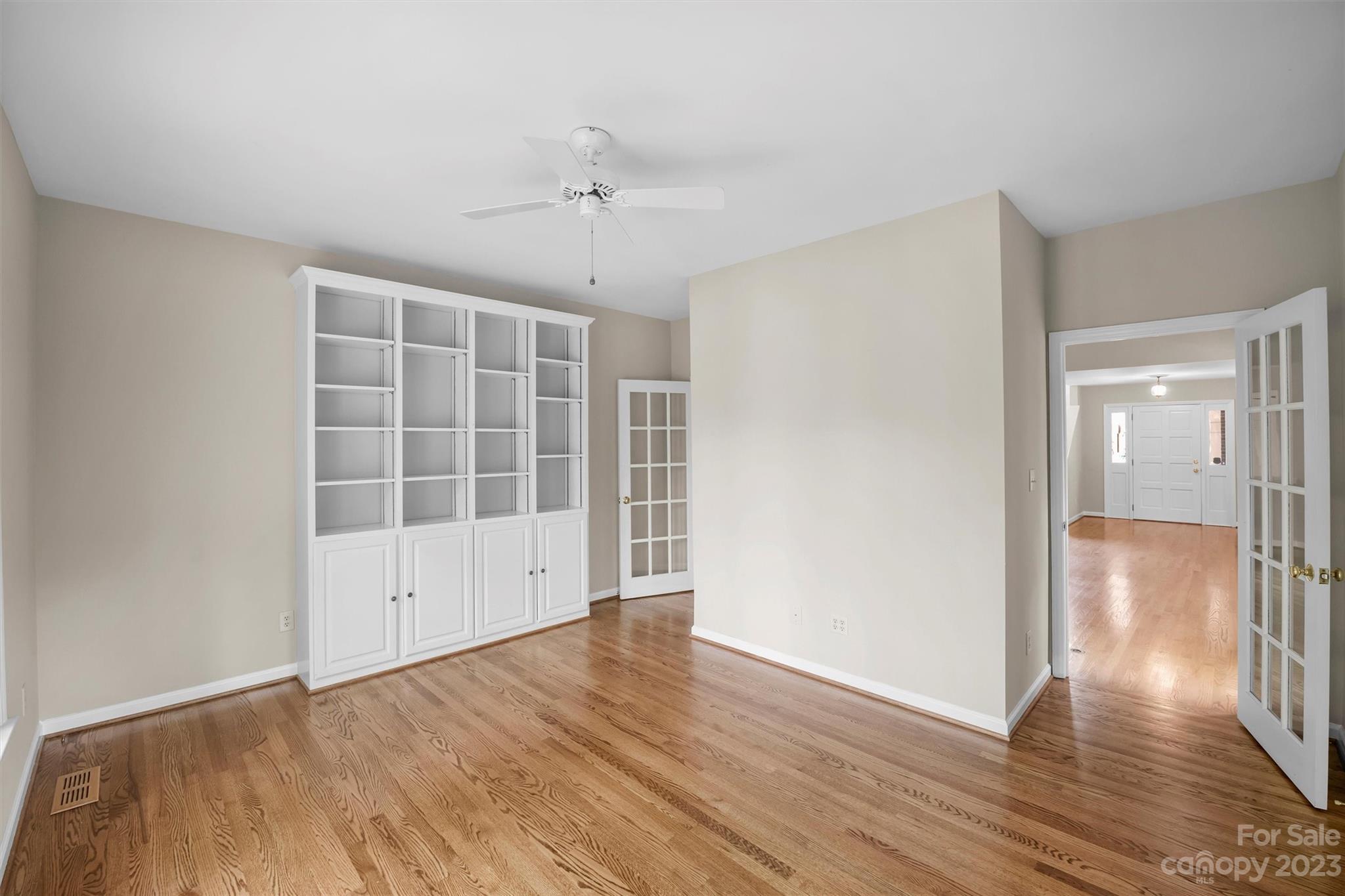 4724 Carson's Pond Road, Unit 104 Charlotte, NC 28226 - Photo 12 of 38 wooden floor in an empty room with a window