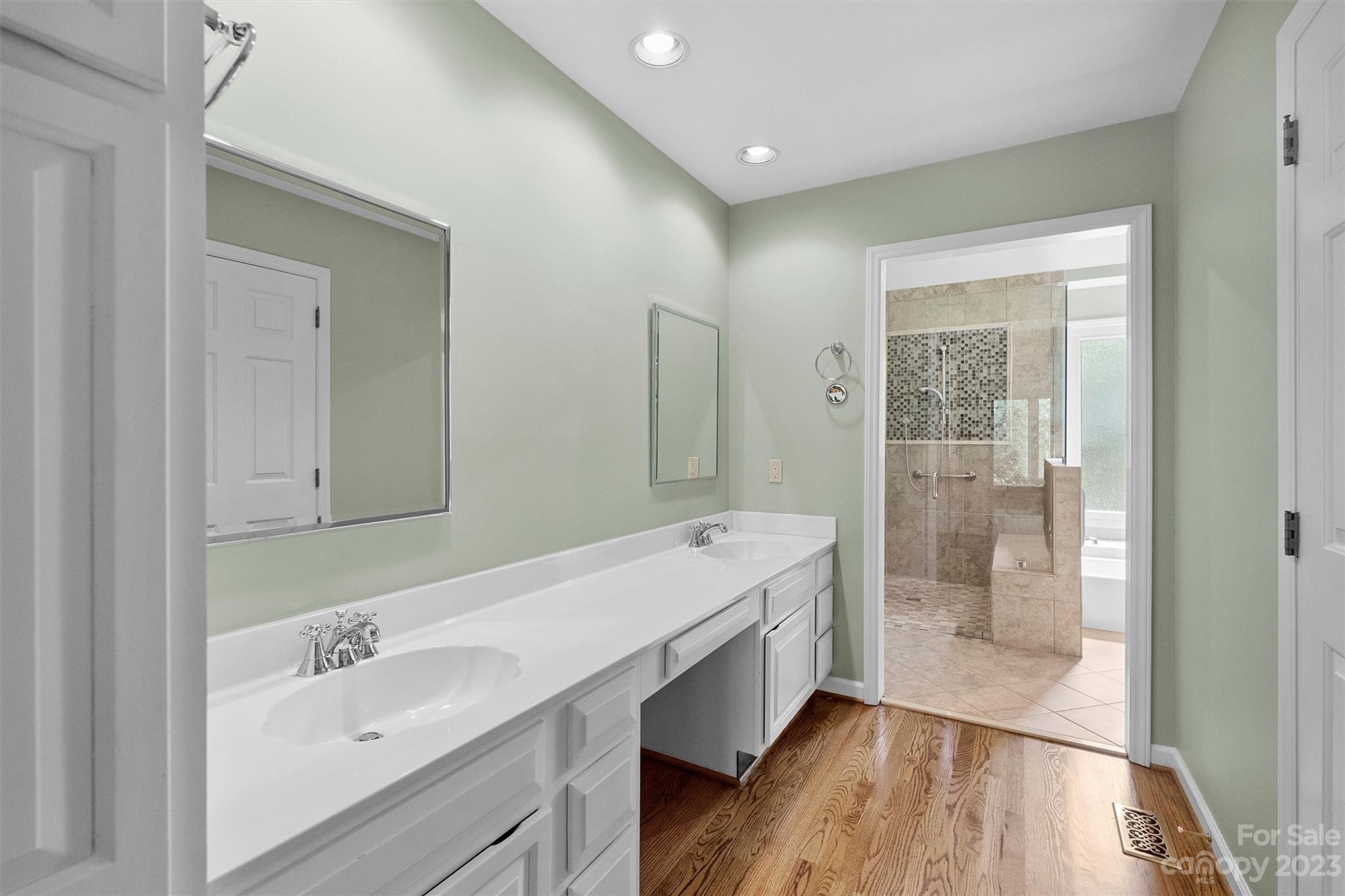 4724 Carson's Pond Road, Unit 104 Charlotte, NC 28226 - Photo 17 of 38 a bathroom with a double vanity sink a mirror and a shower