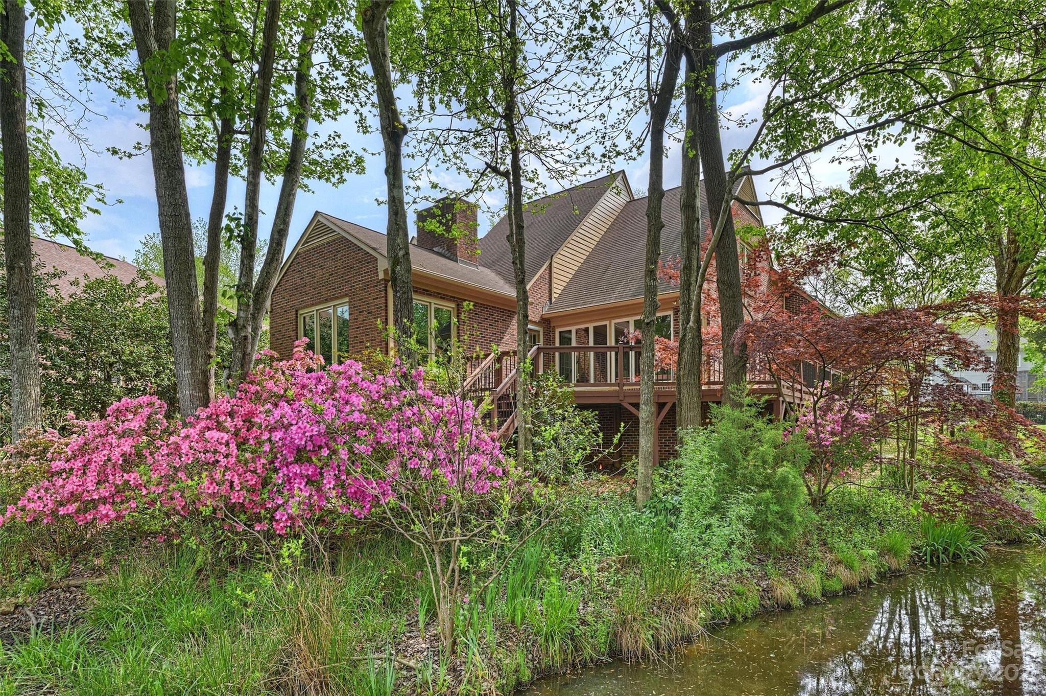 4724 Carson's Pond Road, Unit 104 Charlotte, NC 28226 - Photo 28 of 38 a small garden covered with lots of flower and trees