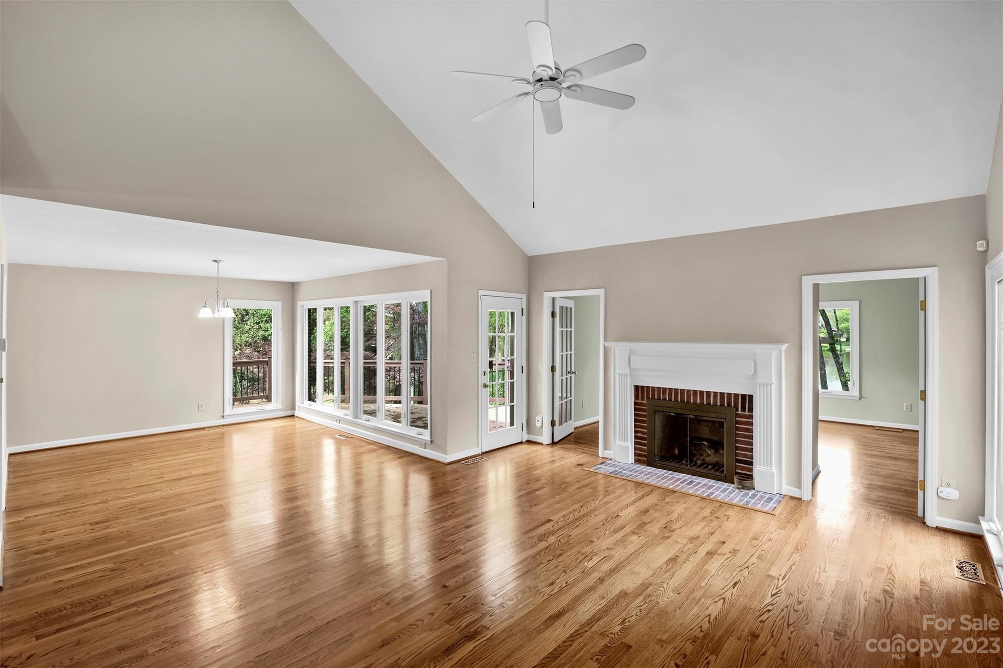 4724 Carson's Pond Road, Unit 104 Charlotte, NC 28226 - Photo 3 of 38 a view of an empty room with wooden floor fireplace and a window