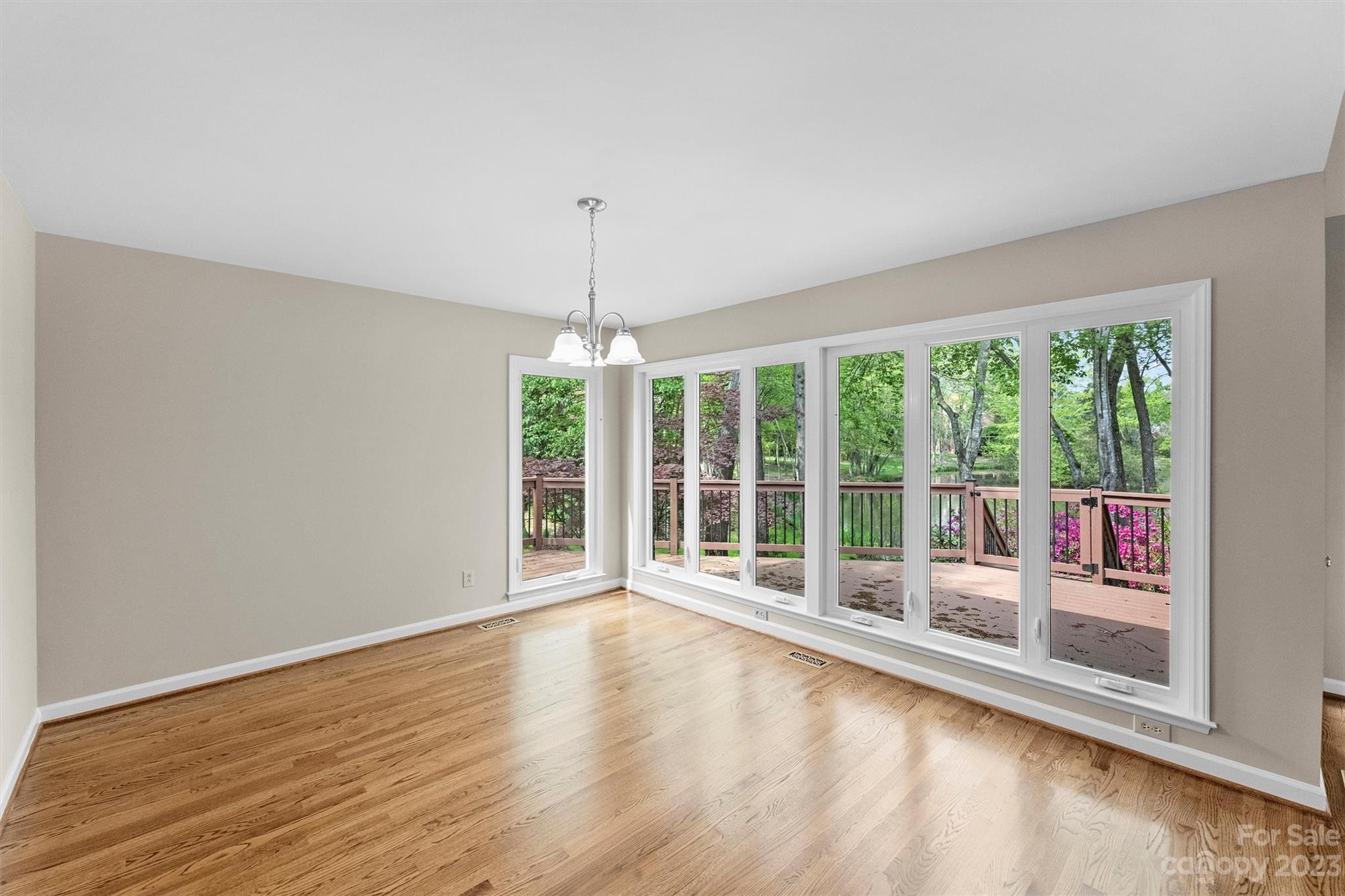4724 Carson's Pond Road, Unit 104 Charlotte, NC 28226 - Photo 4 of 38 a view of an empty room with wooden floor and a window