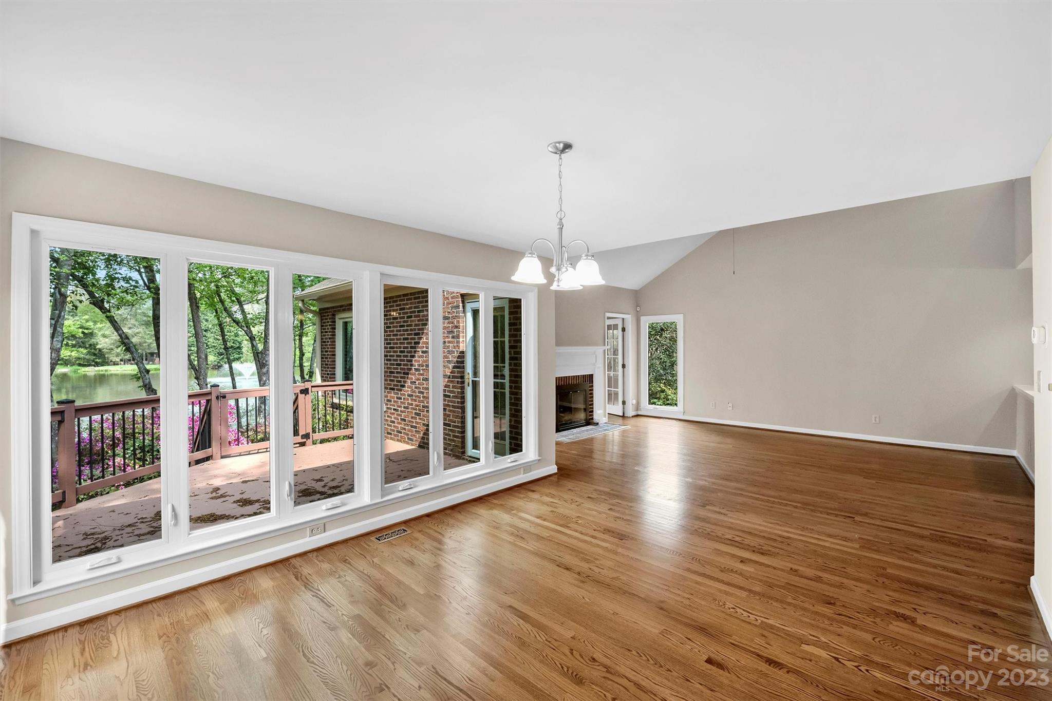 4724 Carson's Pond Road, Unit 104 Charlotte, NC 28226 - Photo 5 of 38 a view of an empty room with wooden floor and a window