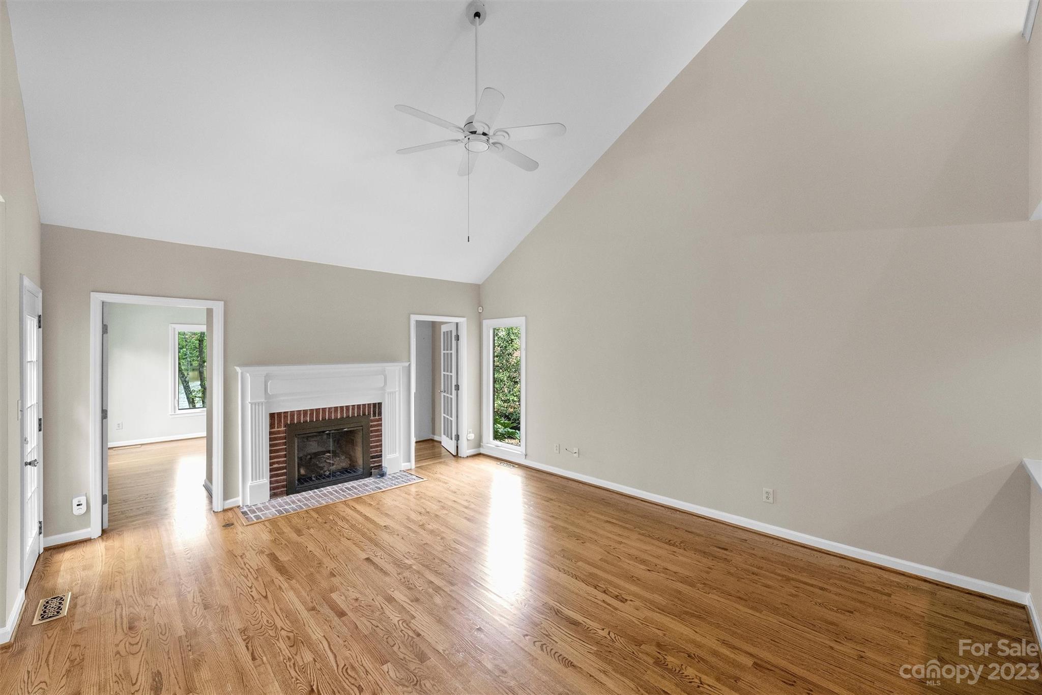 4724 Carson's Pond Road, Unit 104 Charlotte, NC 28226 - Photo 6 of 38 an empty room with wooden floor a fireplace and window