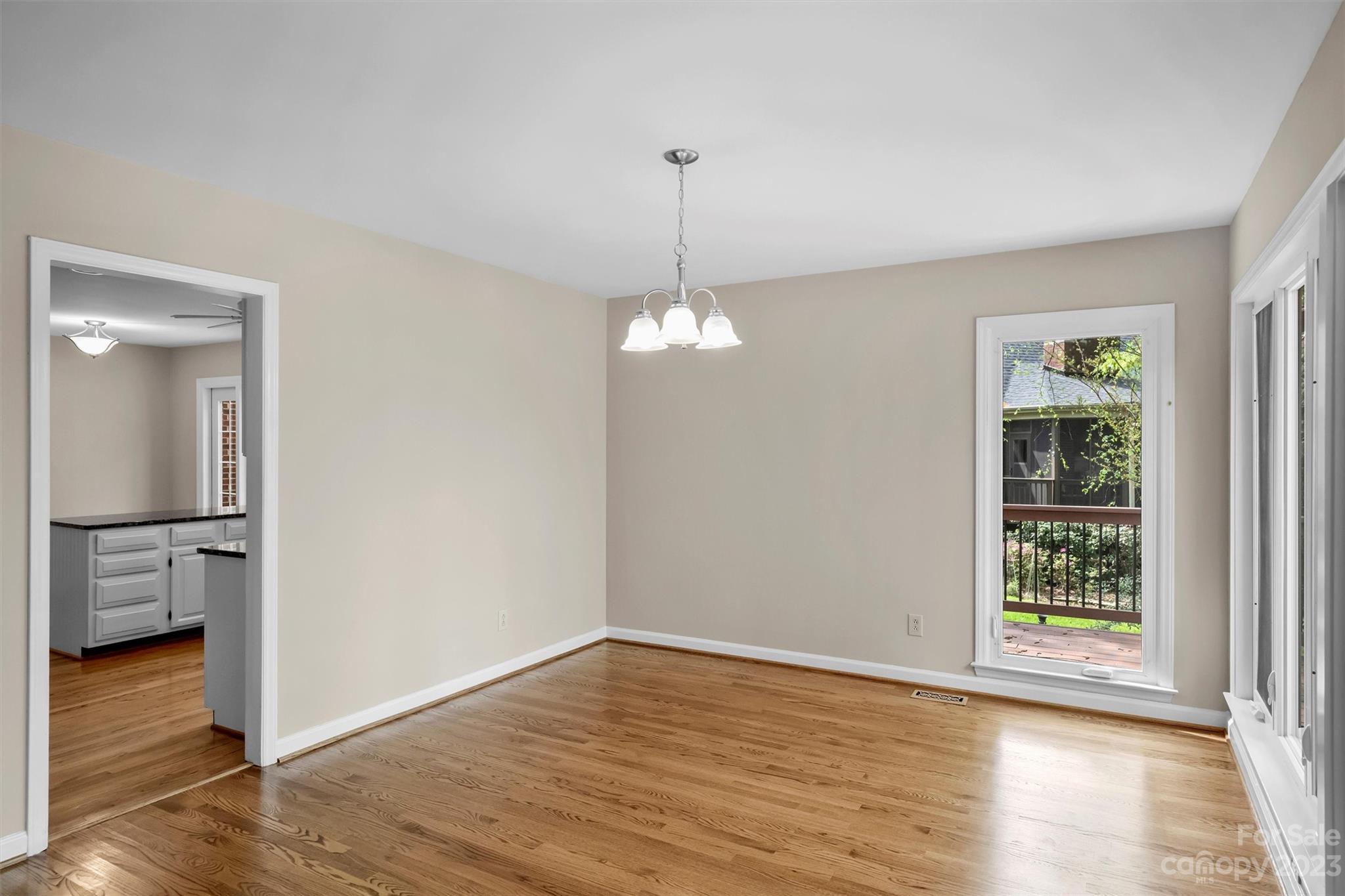 4724 Carson's Pond Road, Unit 104 Charlotte, NC 28226 - Photo 9 of 38 a view of empty room with wooden floor and fan