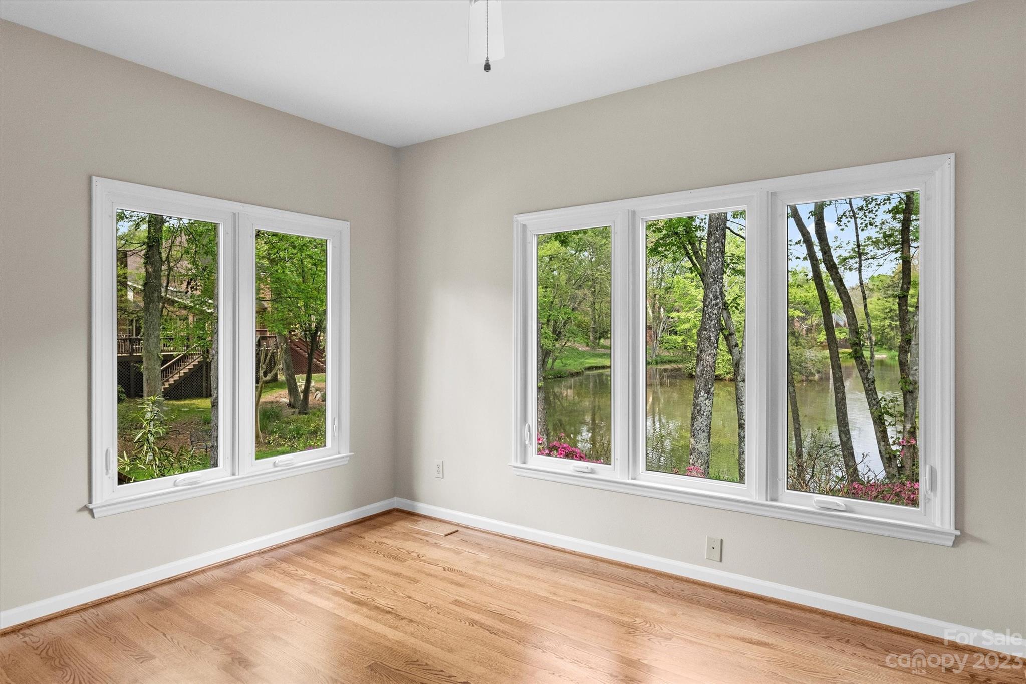 4724 Carson's Pond Road, Unit 104 Charlotte, NC 28226 - Photo 10 of 38 a view of an empty room with wooden floor and a window