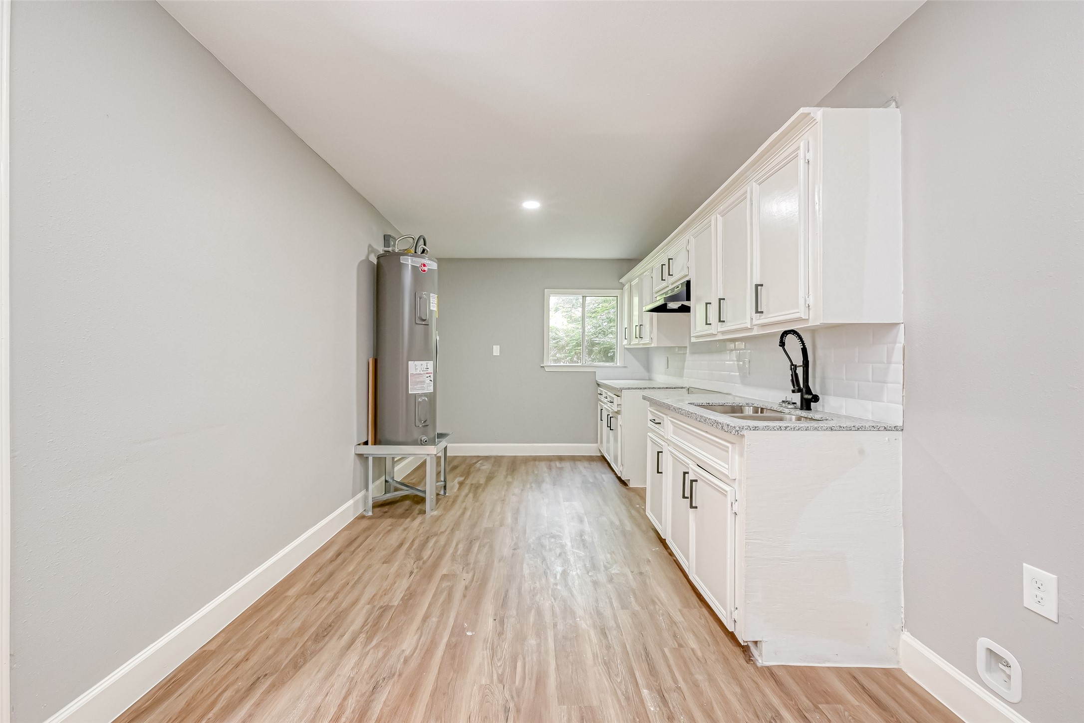 6715 Victoria Street Houston, TX 77020 - Photo 34 of 46 a large kitchen with a sink and wooden floor