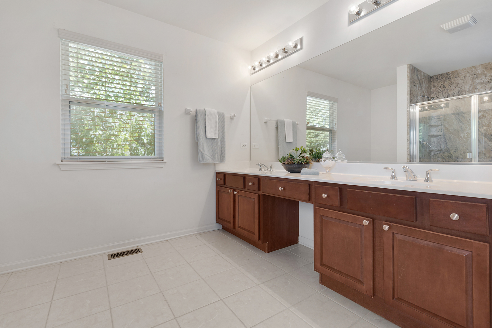 748 Hamilton Way Batavia, IL 60510 - Photo 21 of 36 a spacious bathroom with a granite countertop sink and a mirror