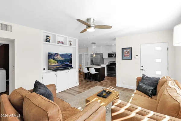 a living room with furniture and a flat screen tv