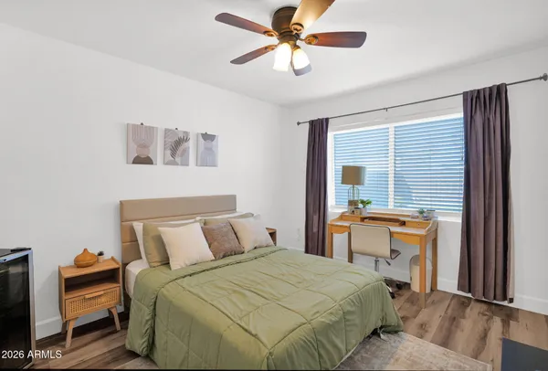 a bedroom with a bed and a chandelier