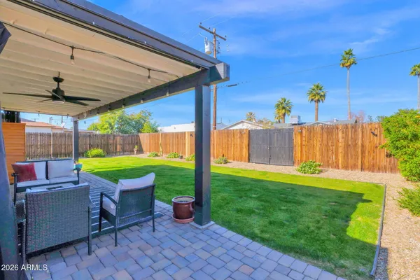 a view of a backyard with sitting area