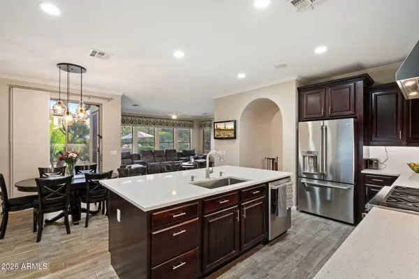 a kitchen with a stove a sink and a refrigerator