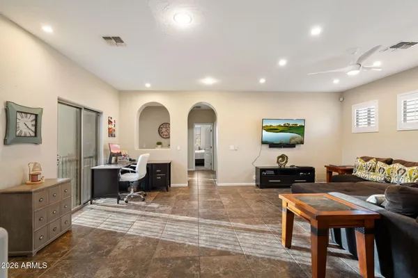 a living room with furniture a large window and a table