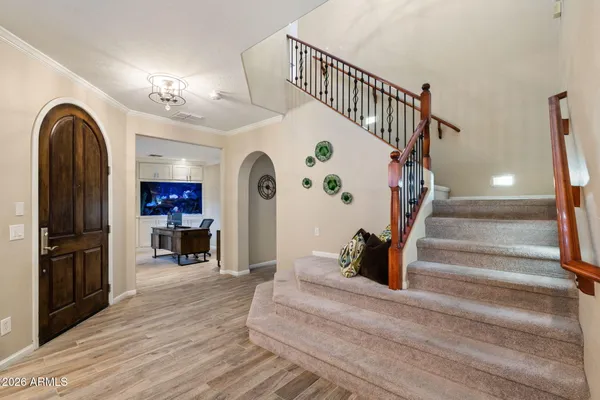 a view of entryway and hall with wooden floor