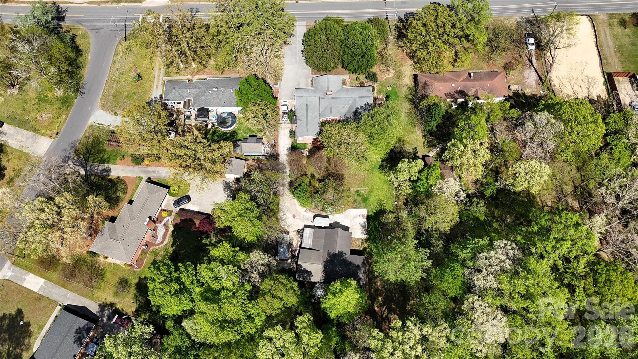 1319 Cathey Road Charlotte, NC 28214 - Photo 29 of 34 an aerial view of a residential apartment building with a yard and parking spaces