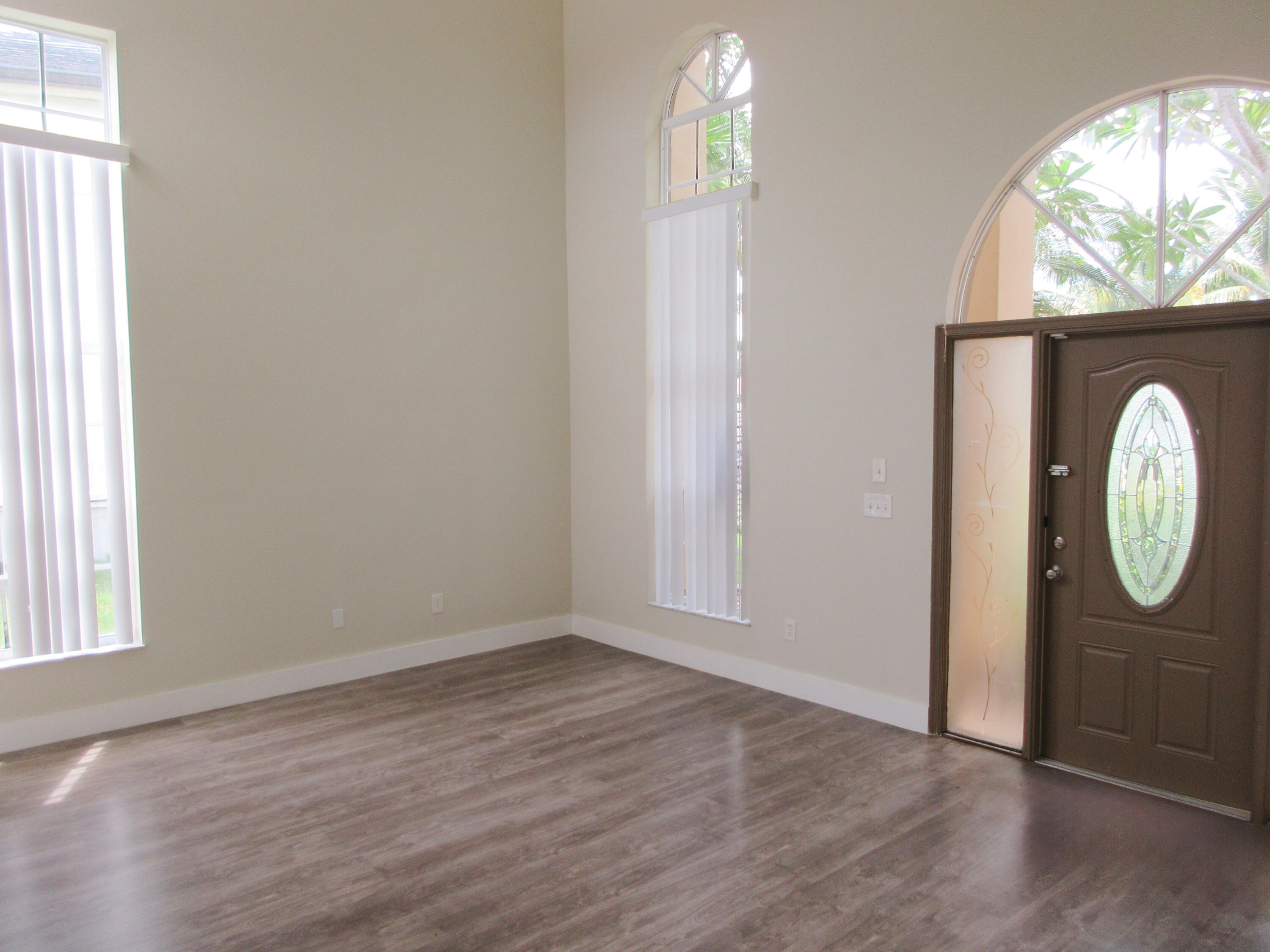 14021 Richwood Place Davie, FL 33325 - Photo 2 of 9 an empty room with wooden floor mirror and windows