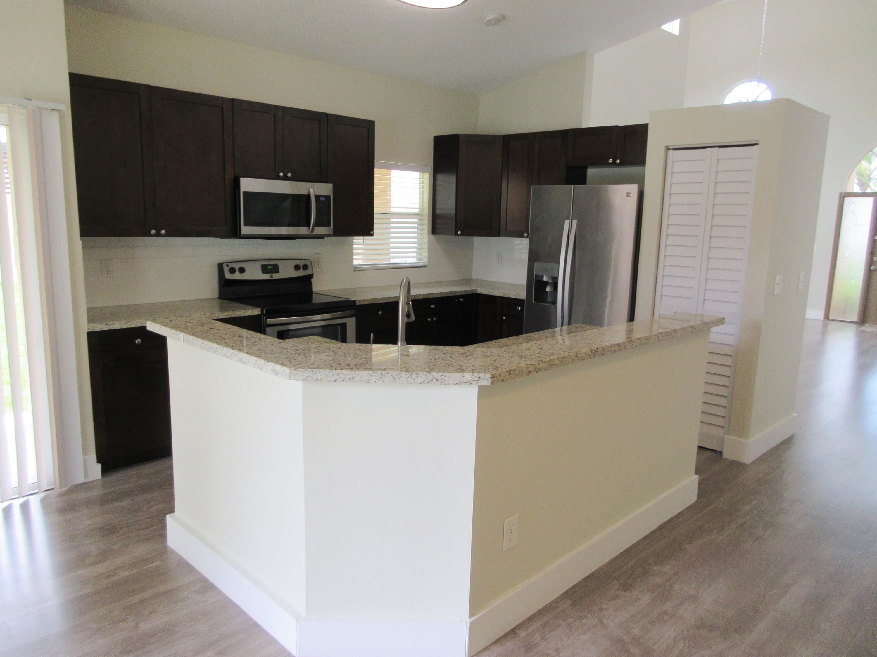 14021 Richwood Place Davie, FL 33325 - Photo 3 of 9 a kitchen with stainless steel appliances a refrigerator a stove a microwave a sink and a refrigerator