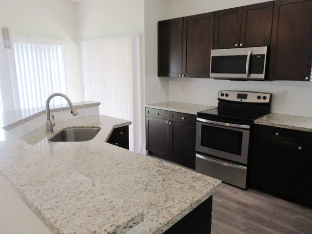 a kitchen with a sink and steel appliances