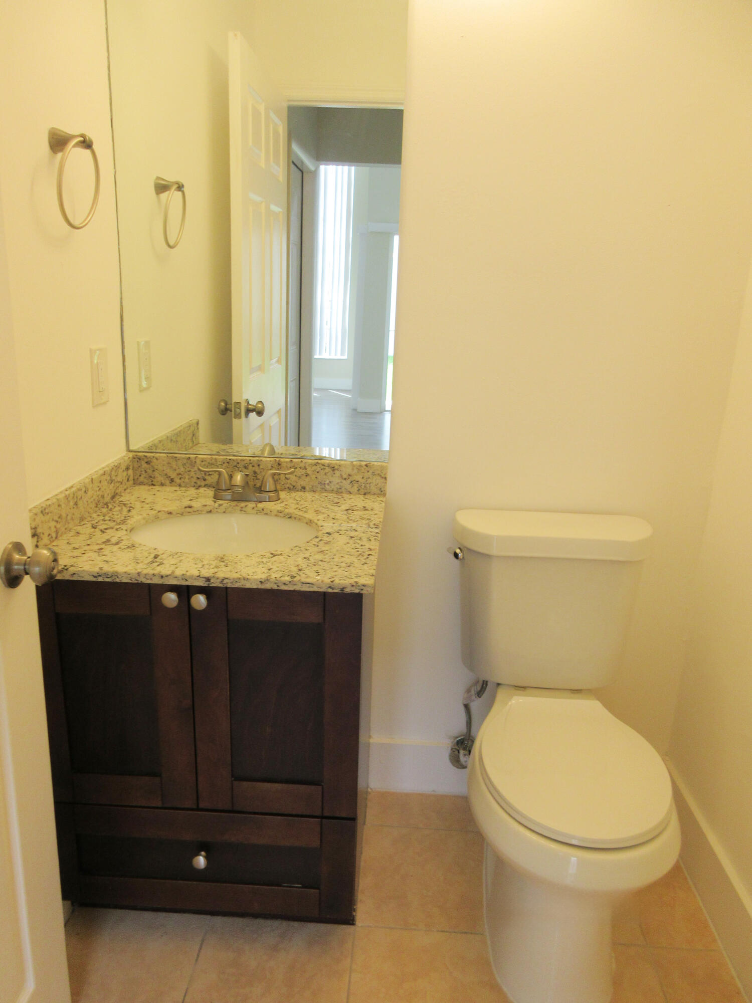14021 Richwood Place Davie, FL 33325 - Photo 6 of 9 a bathroom with a granite countertop toilet and a sink