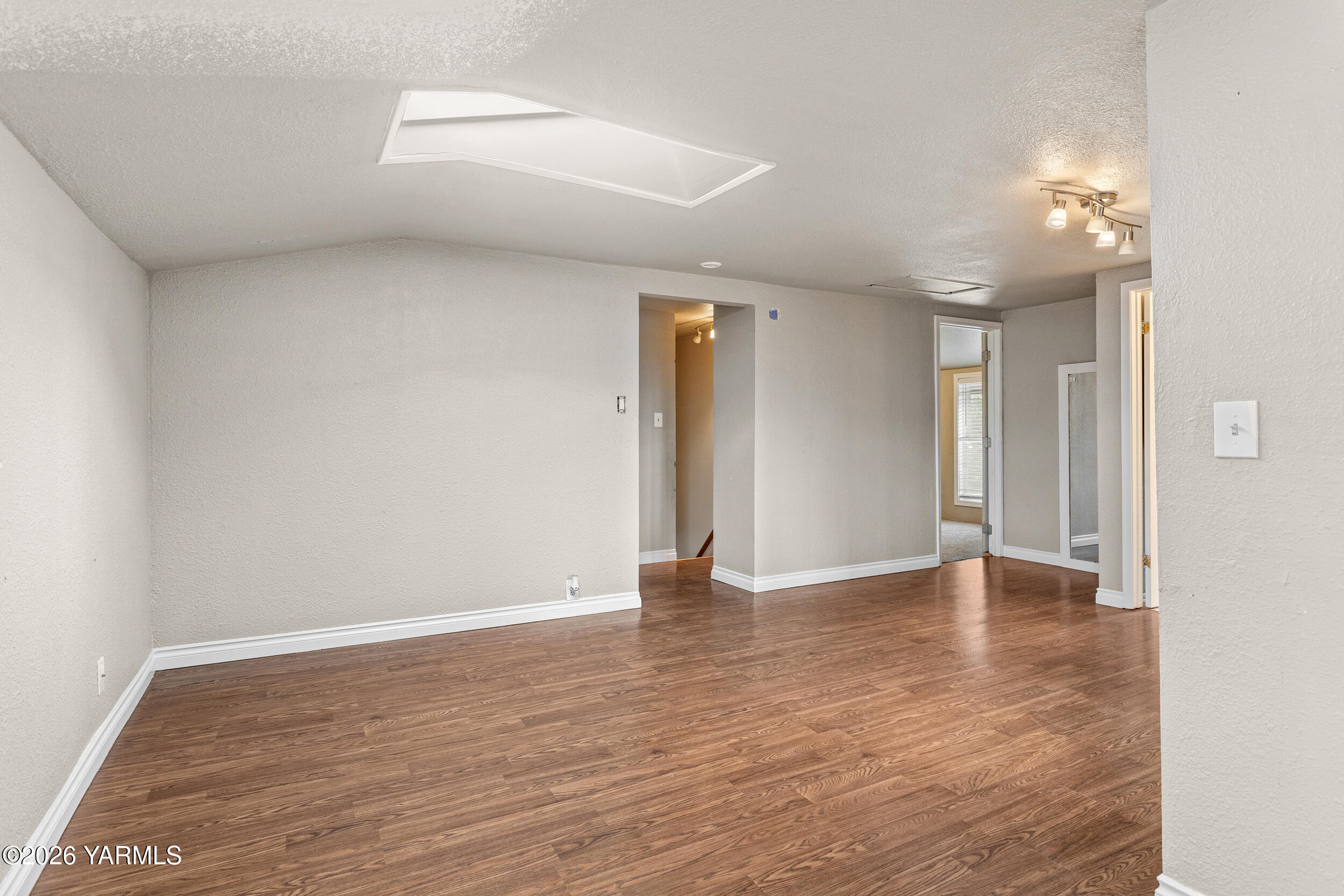 2121 Pleasant Hill Road Selah, WA 98942 - Photo 26 of 38 a view of an empty room with wooden floor and a window