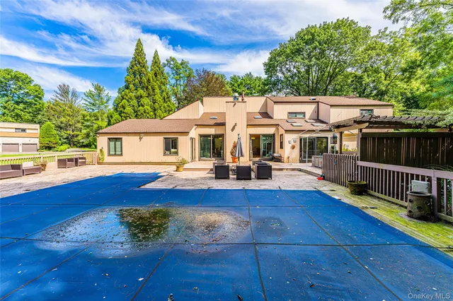 a view of a house with pool and sitting area