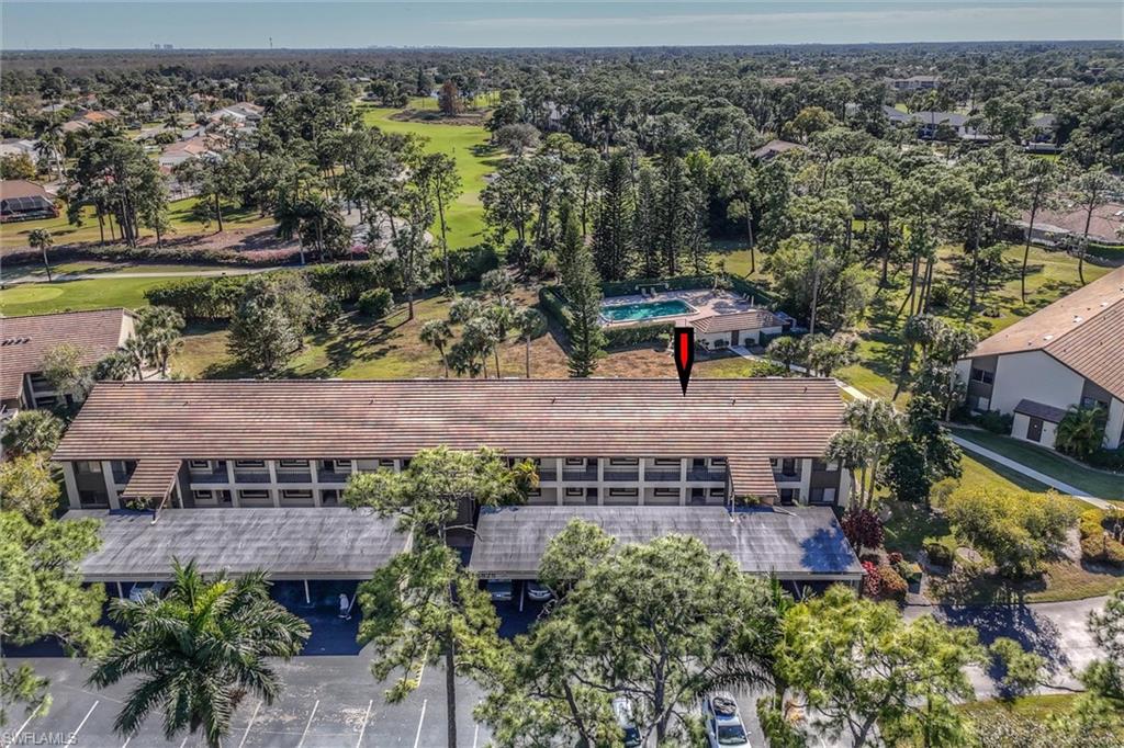 5825 Rattlesnake Hammock Road, Unit 107 Naples, FL 34113 - Photo 32 of 38 an aerial view of a house with garden space and outdoor seating