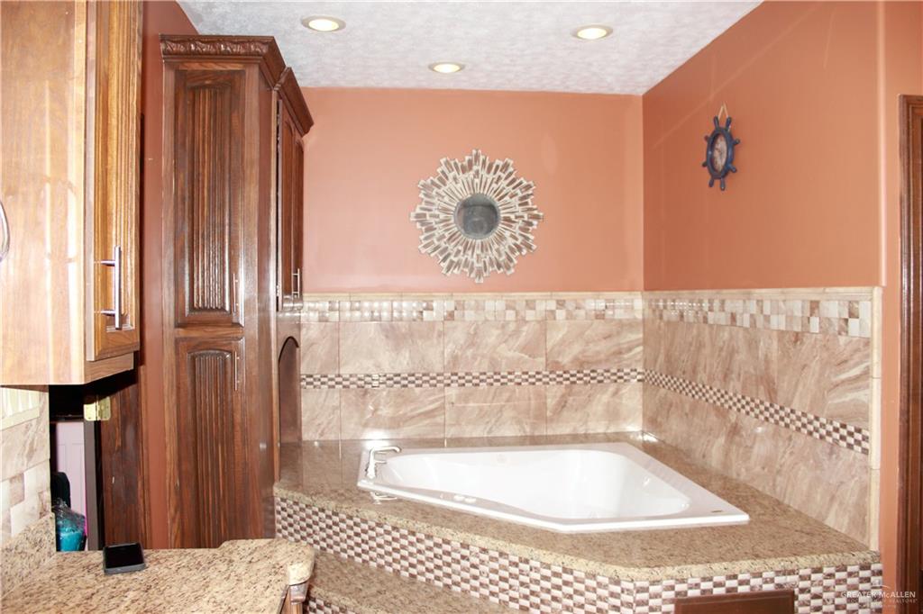 322 North Charco Blanco Road Rio Grande City, TX 78582 - Photo 14 of 28 a bathroom with a bathtub and a shower