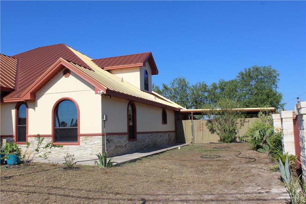 322 North Charco Blanco Road Rio Grande City, TX 78582 - Photo 3 of 28 a front view of a house with a yard