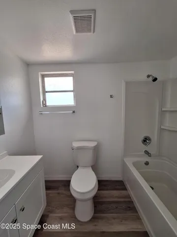 a bathroom with a toilet and a bathtub