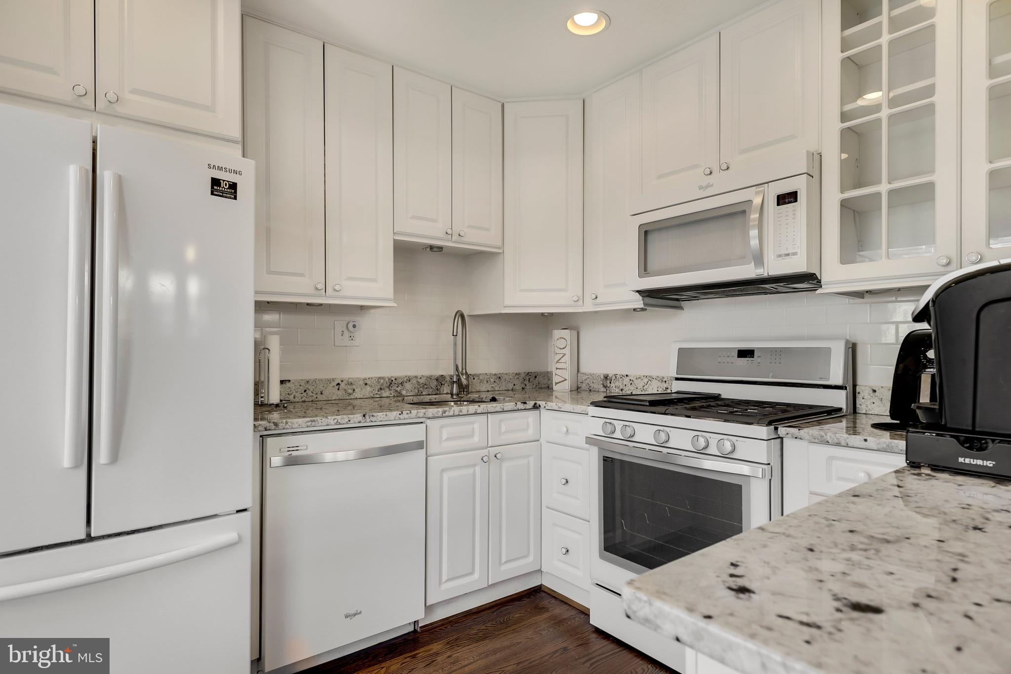 9515 Riley Road Silver Spring, MD 20910 - Photo 13 of 43 a kitchen with stainless steel appliances granite countertop a stove sink and cabinets