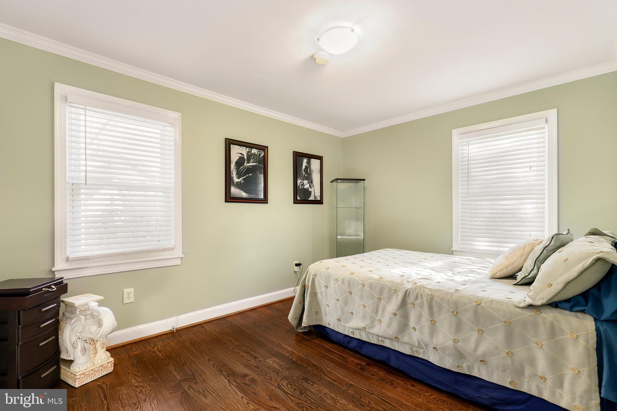 9515 Riley Road Silver Spring, MD 20910 - Photo 20 of 43 a bedroom with a bed and wooden floor