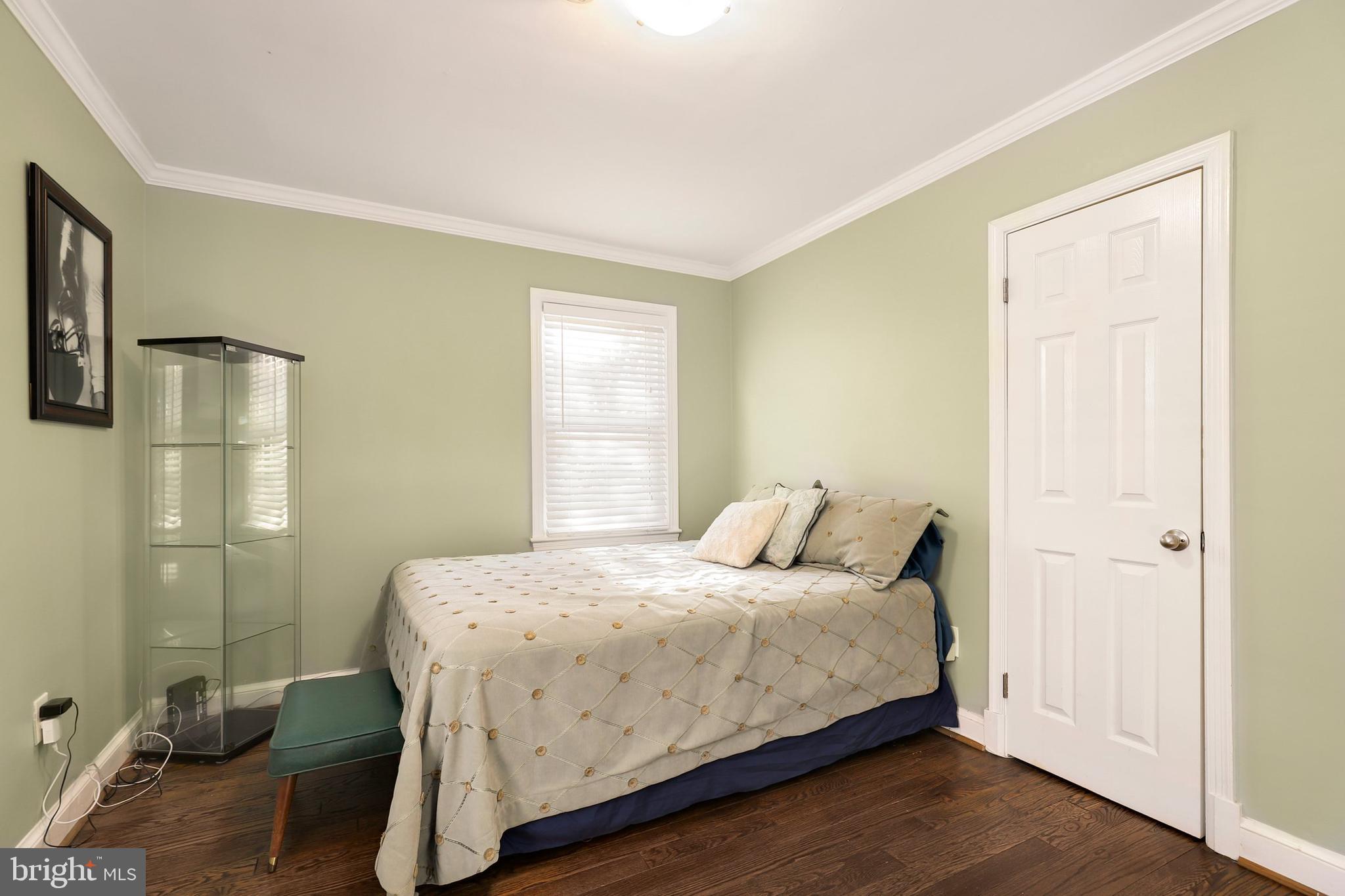 9515 Riley Road Silver Spring, MD 20910 - Photo 21 of 43 a bedroom with a bed and wooden floor
