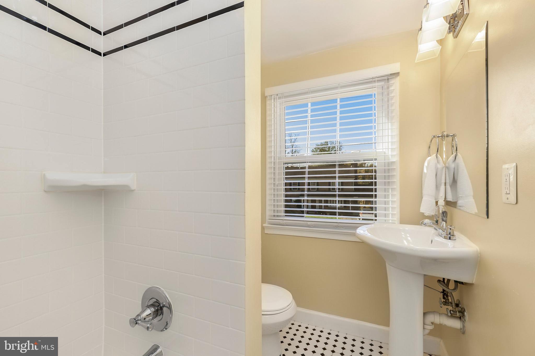9515 Riley Road Silver Spring, MD 20910 - Photo 31 of 43 a bathroom with a sink a toilet and shower