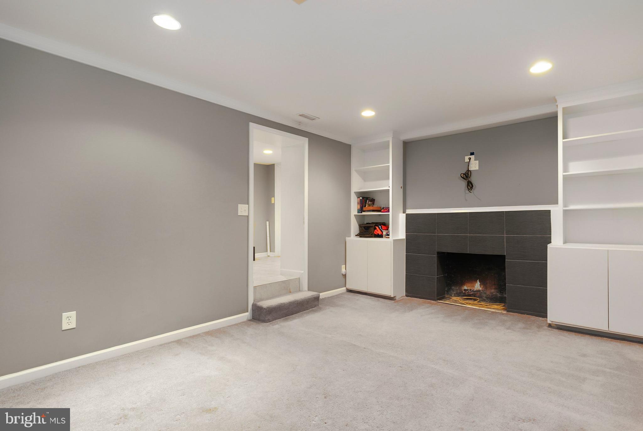 9515 Riley Road Silver Spring, MD 20910 - Photo 35 of 43 a view of empty room with fireplace and wooden floor