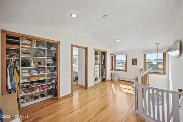 a view of empty room with wooden floor and windows