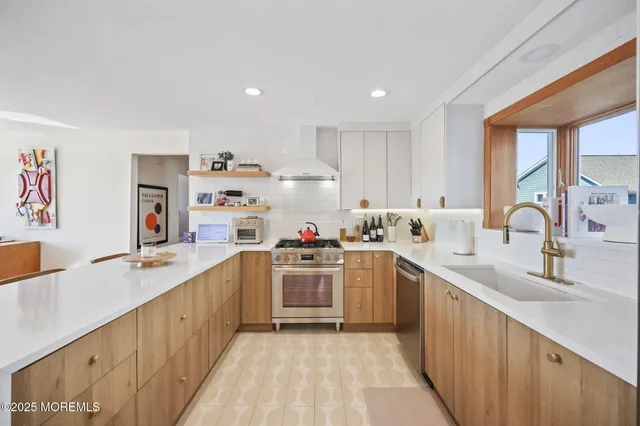a kitchen with stainless steel appliances granite countertop a sink and cabinets
