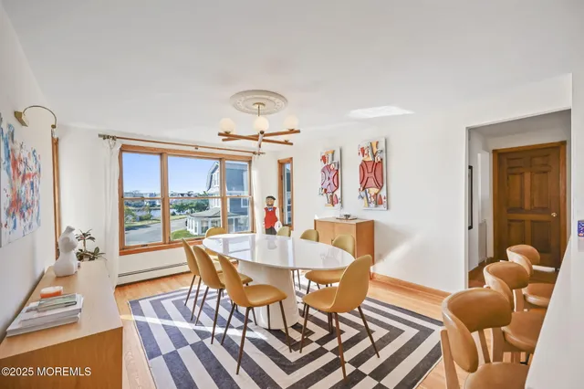 a dining room with furniture and wooden floor