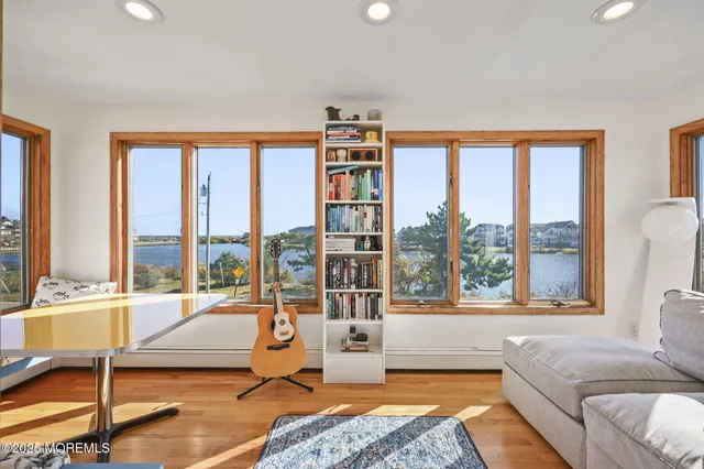 a living room with furniture and a floor to ceiling window