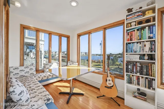 a living room with furniture and a book shelf