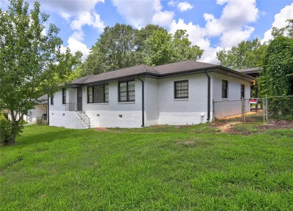 a front view of house with yard and trees