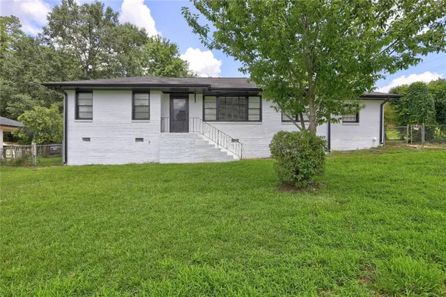 a front view of house with yard and green space