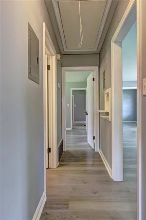 a view of a hallway with wooden floor and staircase