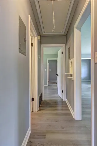 a view of a hallway with wooden floor and staircase