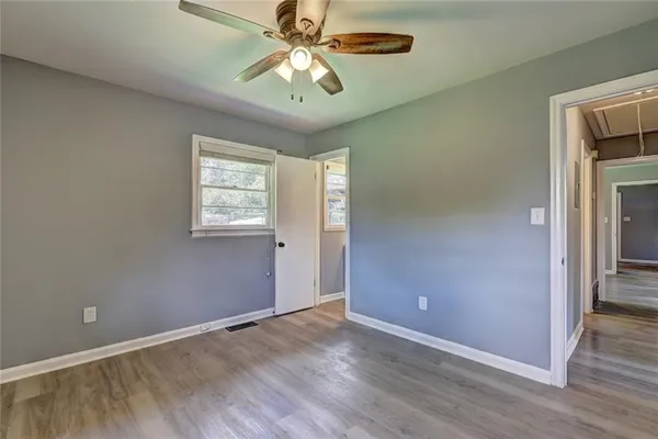 wooden floor in an empty room with a window