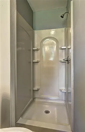 a bathroom with a glass shower door