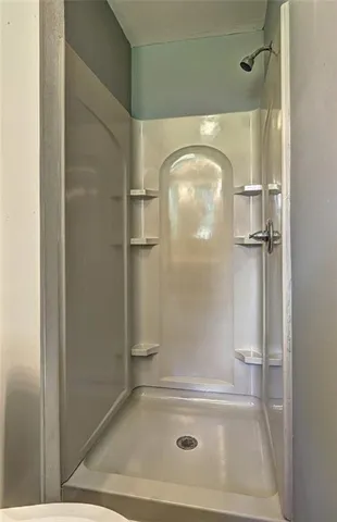 a bathroom with a glass shower door