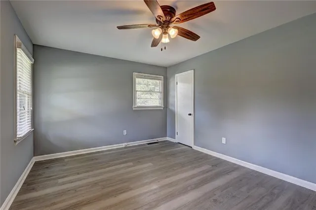 wooden floor in an empty room with a window