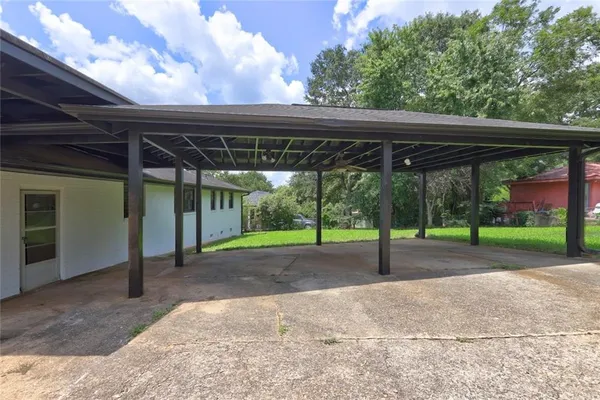 a view of a backyard with wooden fence