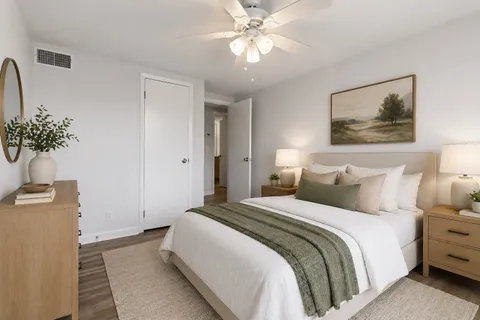 a bedroom with a bed and a chandelier