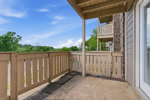 a balcony with wooden floor and city view