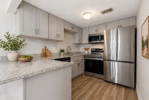 a kitchen with a refrigerator and a sink